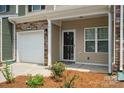 Front entry of townhome with door and garage at 7011 Jane Parks Way, Charlotte, NC 28217