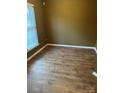An empty bedroom features hardwood floors and a neutral paint, offering versatility and comfort at 7117 Flying Scotsman Dr, Charlotte, NC 28213