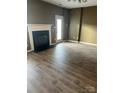 Bright living room boasts a classic fireplace, offering a cozy atmosphere for relaxation at 7117 Flying Scotsman Dr, Charlotte, NC 28213