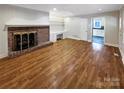 Living room featuring hardwood floors and a brick fireplace at 1005 Woodland Dr, Gastonia, NC 28054