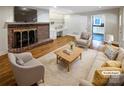 Virtually staged living room with fireplace and hardwood floors at 1005 Woodland Dr, Gastonia, NC 28054