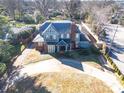 Two-story house with circular driveway, mature trees, and a large backyard at 1024 Queens Rd, Charlotte, NC 28207