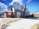 Brick two-story home with a slate roof, large windows, and a spacious front yard at 1024 Queens Rd, Charlotte, NC 28207