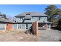 Back of the house with large yard, brick and stucco exterior, and multiple doors at 1024 Queens Rd, Charlotte, NC 28207
