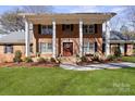 Charming brick home with a welcoming front porch and beautifully landscaped yard at 107 Cambridge Rd, Huntersville, NC 28078