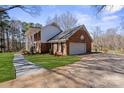 Spacious two-car garage with attached brick home and extended driveway at 107 Cambridge Rd, Huntersville, NC 28078