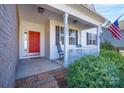 Inviting front porch with rocking chair and American flag at 1361 Colwick Ln, Rock Hill, SC 29732