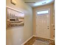Bright entryway featuring wood-look floors, a front door with a transom window, and neutral paint at 1381 6Th Ne St, Hickory, NC 28601