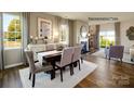 Bright dining room featuring hardwood floors, a fireplace, and large windows at 1427 5Th Street Ne Dr, Hickory, NC 28601