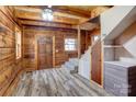 Spacious entryway with exposed beams, wood walls, and stairs to the upper level at 1505 S Ridge Ave, Kannapolis, NC 28083