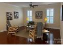 Cozy living room with hardwood floors, neutral decor, and ample natural light from large windows at 18211 Ebenezer Dr, Cornelius, NC 28031