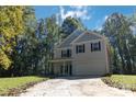 Two-story house with gray siding, black shutters, and a paved driveway at 305 Saddlewood Dr, Gastonia, NC 28056