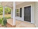 Front entrance with black door and white columns at 305 Saddlewood Dr, Gastonia, NC 28056