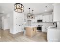 Modern kitchen with white cabinets, an island, and stainless steel appliances at 3070 Swallowtail Ln, Kannapolis, NC 28027