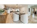 Bright dining room with a large table and modern light fixture at 531 Manhasset Rd, Charlotte, NC 28209