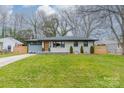 Charming ranch home with gray and white brick exterior and landscaped yard at 531 Manhasset Rd, Charlotte, NC 28209