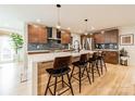 Modern kitchen with wooden cabinets, stainless steel appliances, a large island, and hardwood floors at 531 Manhasset Rd, Charlotte, NC 28209