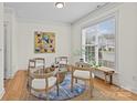 Cozy sitting area with four chairs, a table, an area rug, and a large window with natural light at 6823 Dunton St, Huntersville, NC 28078