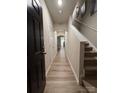 Inviting hallway features modern flooring, neutral walls, and access to the upper level via carpeted stairs at 7132 Somerford Rd, Charlotte, NC 28215