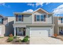 Two-story house with gray siding, white garage door, and landscaping at 9353 Creedmore Hills Dr, Charlotte, NC 28214