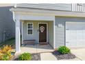 House entrance with brown door, small bench, and decorative wreath at 9353 Creedmore Hills Dr, Charlotte, NC 28214