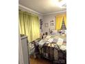 Bedroom with a patchwork quilt, and yellow curtains at 160 Brookwood Ne Ave, Concord, NC 28025