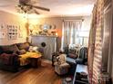 Living room with hardwood floors, fireplace and comfortable seating at 160 Brookwood Ne Ave, Concord, NC 28025