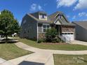 Two-story home with stone and siding facade, a well-kept lawn, and an attached garage at 1605 Appledale Ct # 116, Fort Mill, SC 29715