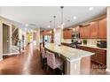 Spacious kitchen featuring granite countertops, a large island with seating, and stainless steel appliances at 1605 Appledale Ct # 116, Fort Mill, SC 29715