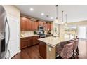 Well-lit kitchen featuring granite countertops, a central island with seating, and abundant cabinetry at 1605 Appledale Ct # 116, Fort Mill, SC 29715