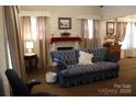 Living room with blue sofa and fireplace at 1724 Lowder St, Albemarle, NC 28001