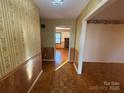 View of an entryway with wood flooring and wallpaper, leading to living room at 190 Nine Patch Ln, Taylorsville, NC 28681