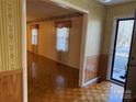 Living room with wood floors, wallpaper, and a view of the exterior at 190 Nine Patch Ln, Taylorsville, NC 28681