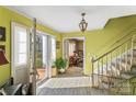 Bright entryway with staircase and view into the living room at 1968 12Th Street Ne Pl, Hickory, NC 28601