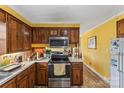 Kitchen with wood cabinets, stainless steel appliances, and vinyl flooring at 1968 12Th Street Ne Pl, Hickory, NC 28601