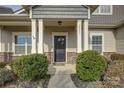 A welcoming front entryway with large white columns and a black front door with wreath at 2001 Yellow Daisy Dr, Matthews, NC 28104