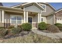 Close up of the front of the home with a well maintained yard and welcoming entryway at 2001 Yellow Daisy Dr, Matthews, NC 28104