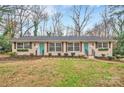 Three-unit brick building with teal doors and updated landscaping at 2025 Ibis Ct, Charlotte, NC 28205