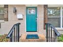 Teal front door with black metal railing and welcome mat at 2025 Ibis Ct, Charlotte, NC 28205