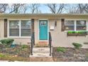 Charming teal front door and brick facade enhance curb appeal at 2027 Ibis Ct, Charlotte, NC 28205