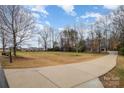 Curved driveway and landscaping leading to a two story home at 2101 Darian Way, Waxhaw, NC 28173