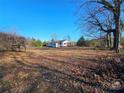 White house with covered porch and spacious yard at 211 Forgotten Ln, Bessemer City, NC 28016