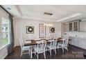 Farmhouse style dining room with long wooden table and statement wall at 2178 Grist Mill Dr, Concord, NC 28025