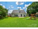 Lush backyard featuring a wooden playset and a spacious, well-maintained lawn at 247 Aylesbury Ln, Indian Trail, NC 28079
