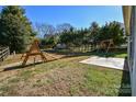 Grass backyard with wooden playset and patio at 247 Aylesbury Ln, Indian Trail, NC 28079