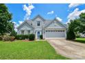 Inviting two-story home featuring a well-maintained lawn and a convenient two-car garage at 247 Aylesbury Ln, Indian Trail, NC 28079