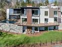 A backyard featuring a deck with outdoor seating and a swimming pool, perfect for entertaining, with green space at 2832 Arcadia Ave, Charlotte, NC 28209