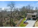 Modern home featuring a stylish exterior, expansive lawn, and views of the surrounding river and natural landscape at 2832 Arcadia Ave, Charlotte, NC 28209