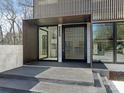 Covered front entrance featuring a black privacy door, modern design and glass accents at 2832 Arcadia Ave, Charlotte, NC 28209