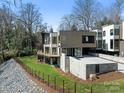 A modern home showcasing its deck, backyard, and stylish architectural details, complemented by a well-maintained lawn at 2832 Arcadia Ave, Charlotte, NC 28209